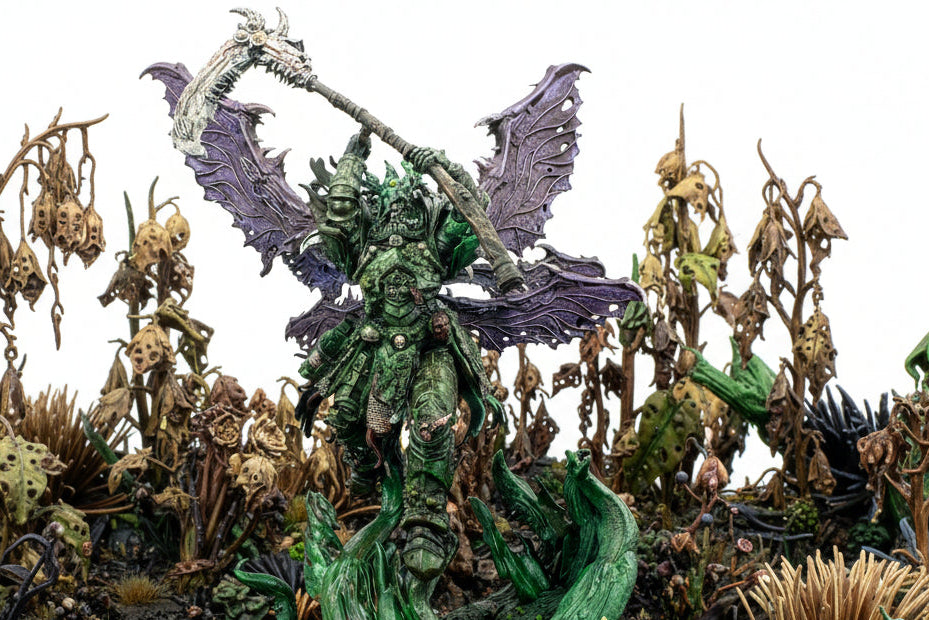 Fantasy figurine with green armor and purple wings on a white background