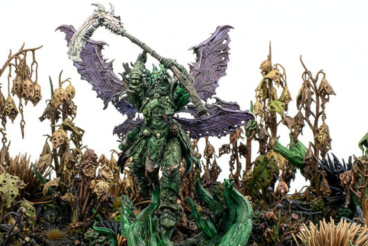 Fantasy figurine with green armor and purple wings on a white background